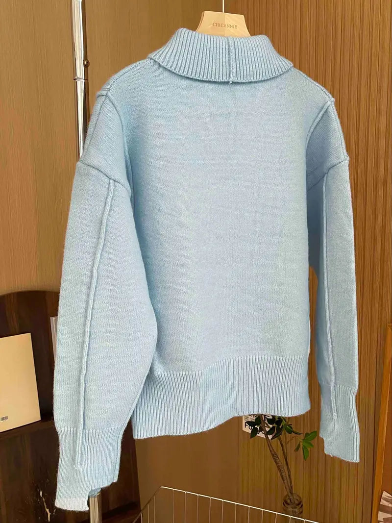 Women's loose-fit knit sweater with stand collar and dropped shoulders, designed by Homixa, shown on a model.