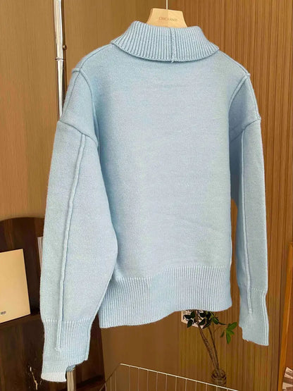 Women's loose-fit knit sweater with stand collar and dropped shoulders, designed by Homixa, shown on a model.