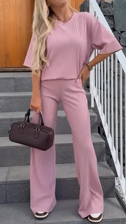 Homixa women's lounge two-piece set with relaxed-fit top and straight-leg pants, shown on a model in a cozy indoor setting.