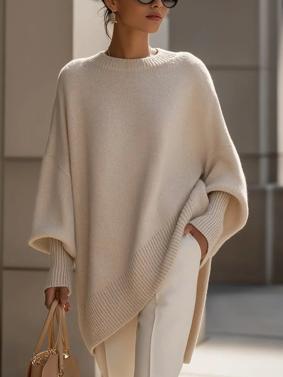 Women’s oversized batwing-sleeve knit sweater by Homixa with flowing drape and soft, cozy fabric, shown on a model.