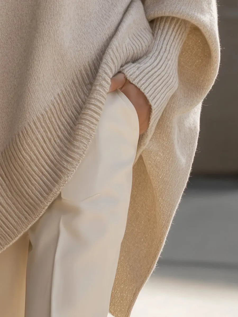 Woman wearing a Homixa oversized batwing-sleeve knit sweater with flowing drape and soft, cozy fabric.
