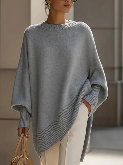 Women's oversized batwing-sleeve knit sweater by Homixa with flowing drape and soft, cozy fabric, shown on a model.