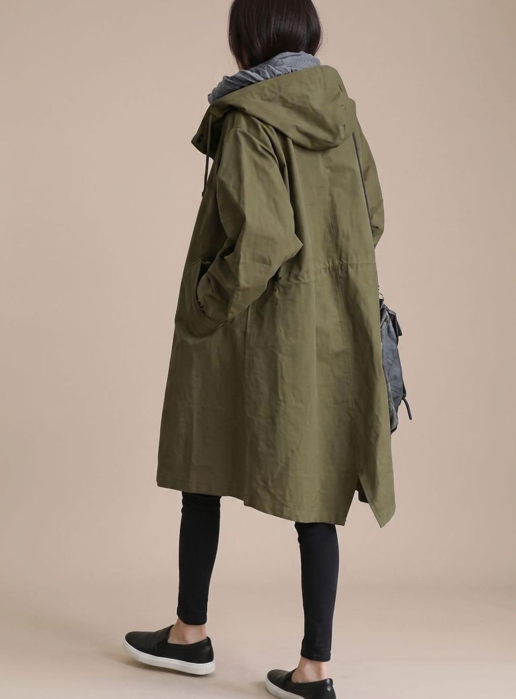 Women’s oversized hooded trench coat by Homixa featuring Korean-inspired midlength cut, shown on a model in a stylish outdoor setting.