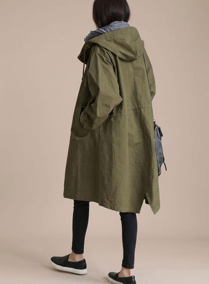 Women’s oversized hooded trench coat by Homixa featuring Korean-inspired midlength cut, shown on a model in a stylish outdoor setting.