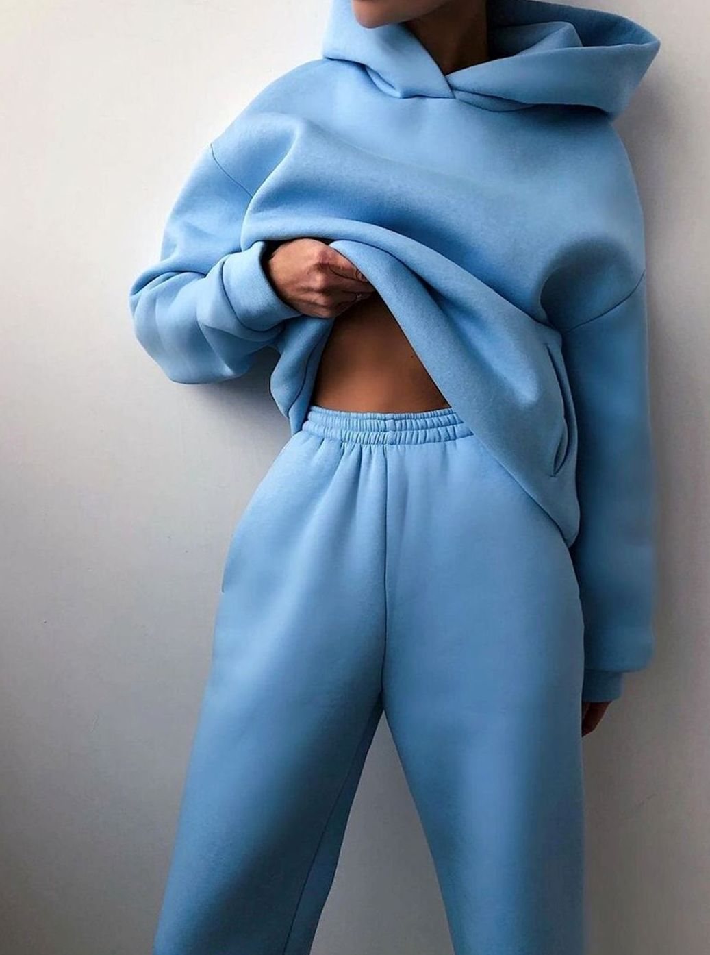 Women's oversized knit tracksuit set by Homixa featuring a hooded sweater and matching jogger pants, styled for casual comfort.