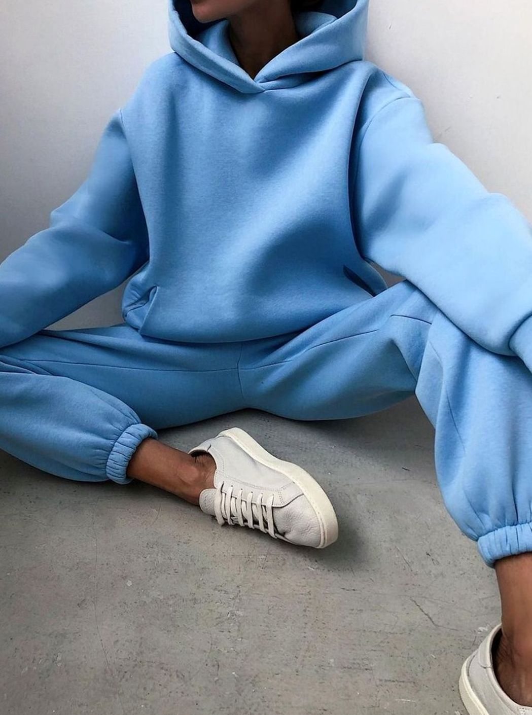 Women's oversized knit tracksuit set by Homixa featuring a hooded sweater and matching jogger pants, shown in a cozy, relaxed fit.