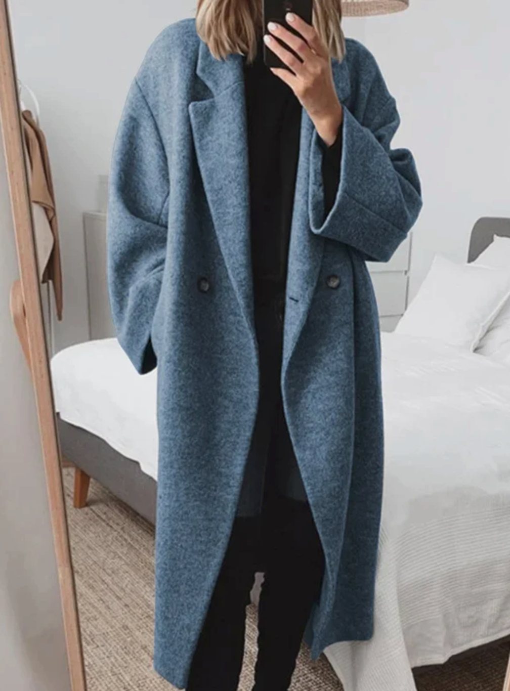 Women's oversized wool coat by Homixa with lapels and two large patch pockets, shown in a long, cozy, and stylish outerwear design.