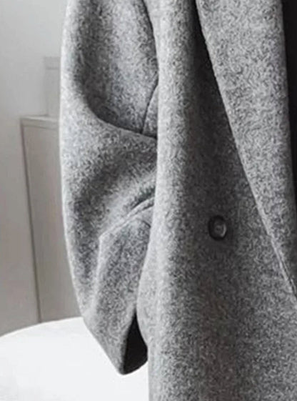 Women’s oversized long wool coat by Homixa featuring a turn-down collar and deep patch pockets, stylish and warm for winter.