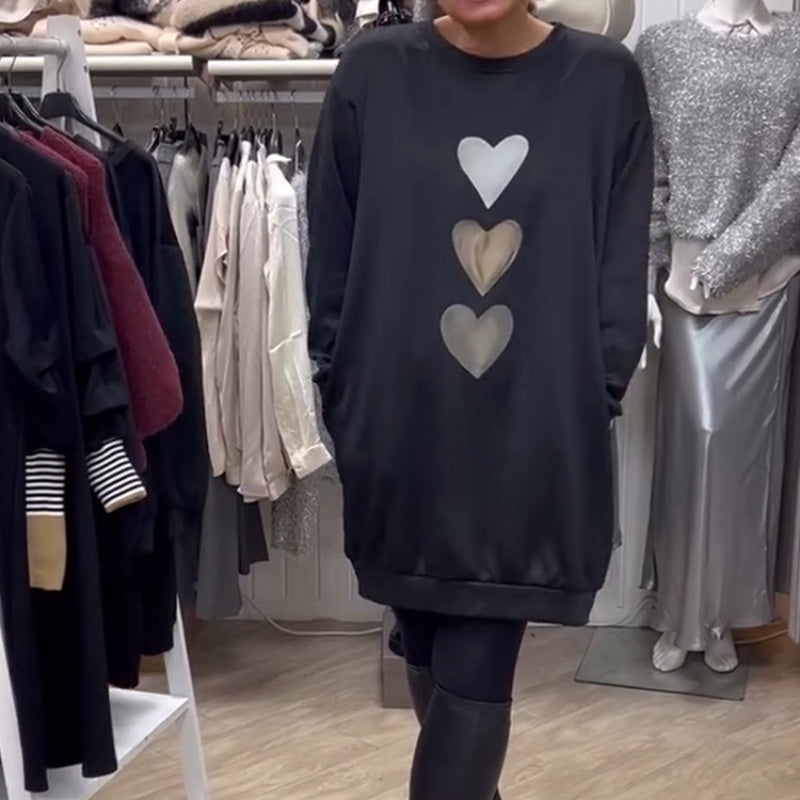 Women's oversized sweatshirt dress by Homixa with stacked heart graphic and ribbed hem, relaxed fit and cozy style.