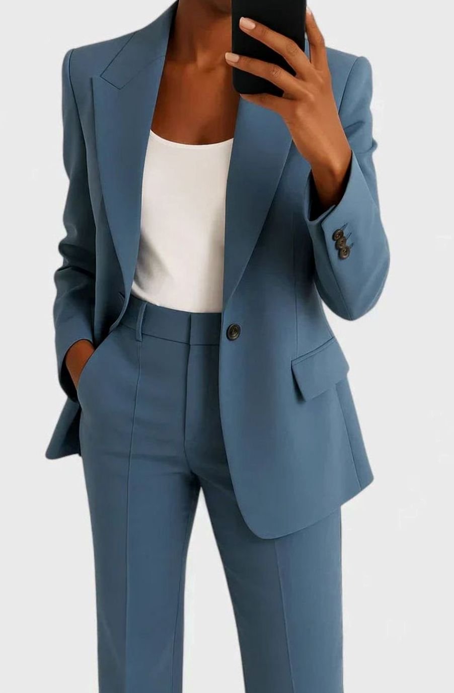 Women's pant suit by Homixa featuring a tailored fitted blazer, flared pants, and high-waist cut in a stylish two-piece set.