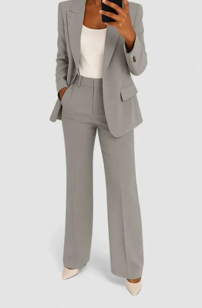 Women's two-piece pant suit by Homixa featuring a tailored fitted blazer, flared pants, and high-waist cut, perfect for professional wear.