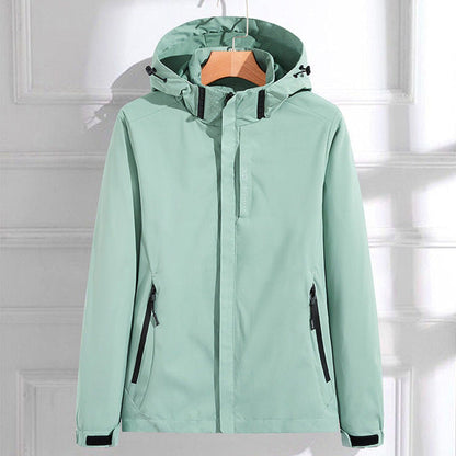 Women's polyester rain jacket by Homixa featuring a removable hood, double zipper, and adjustable fit for weather protection.