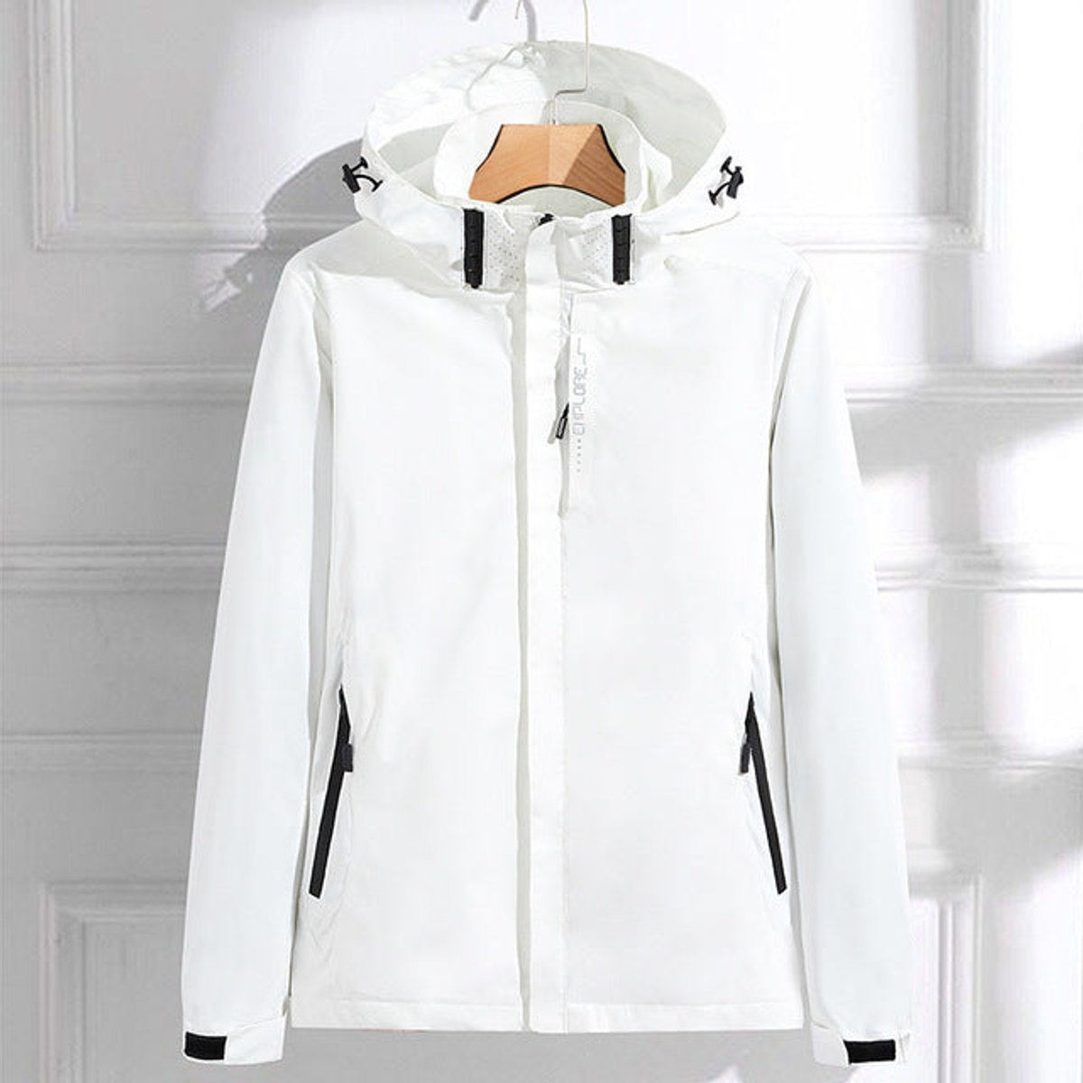 Women’s polyester rain jacket by Homixa featuring a removable hood, double zip closure, and adjustable fit.