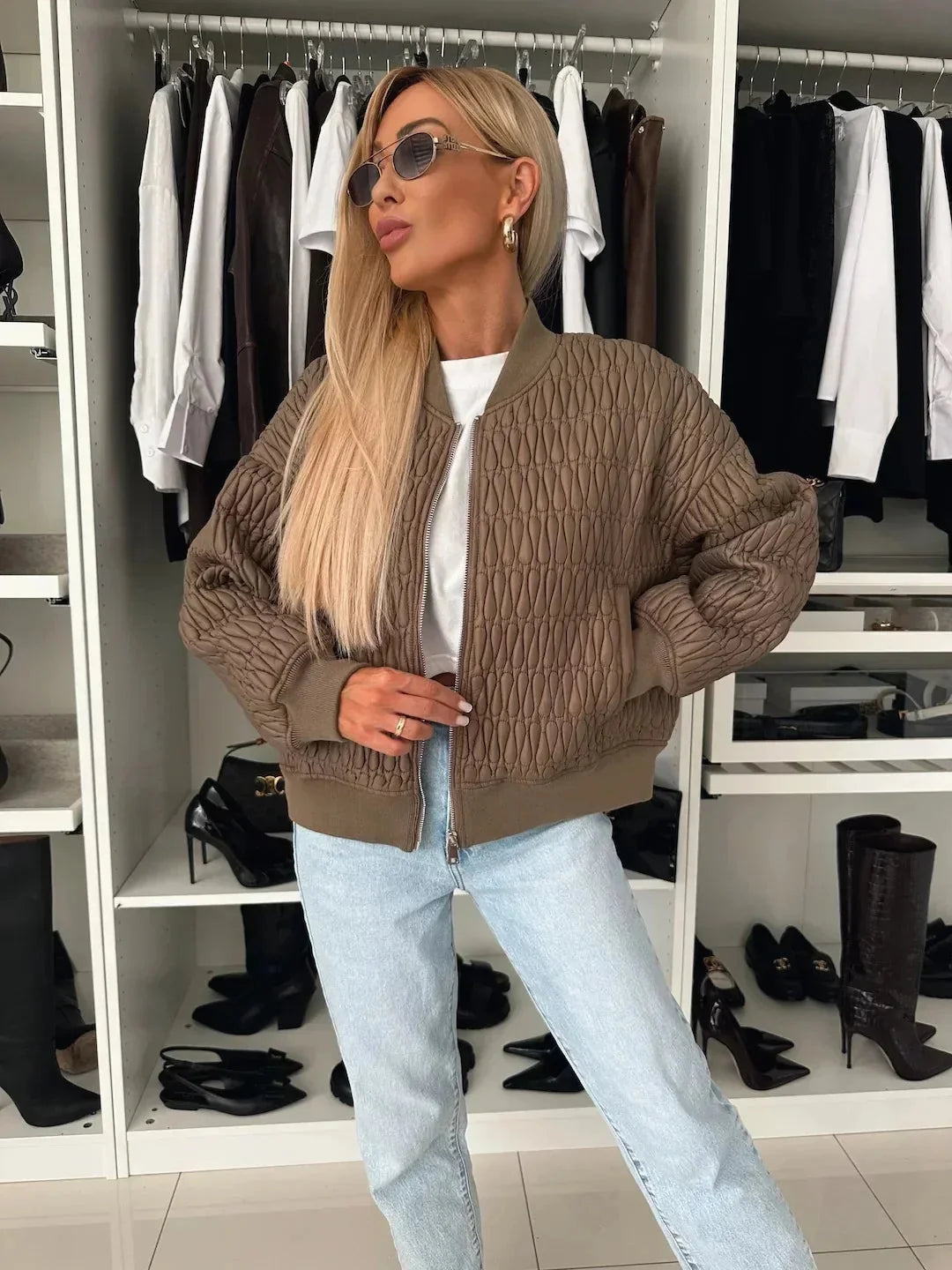 Women's quilted bomber jacket by Homixa featuring a zip-front closure and a structured silhouette, displayed on a model.