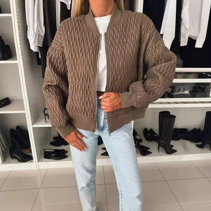 Women's quilted bomber jacket by Homixa with zip-front closure and structured silhouette, showing the stylish design and padded texture.