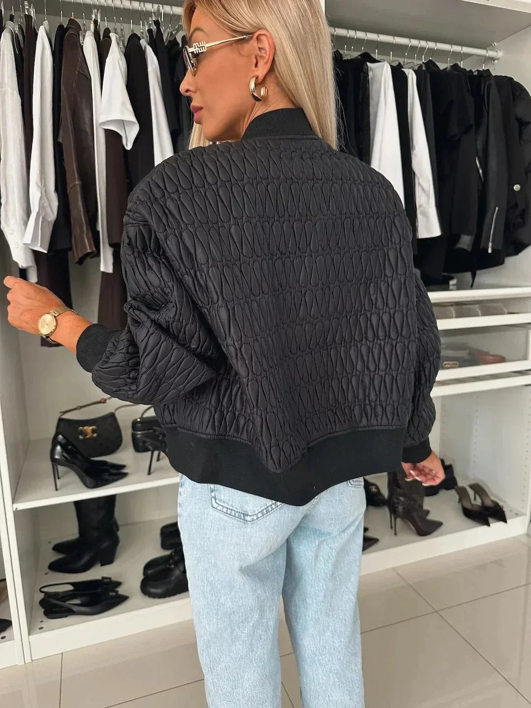 Women's quilted bomber jacket by Homixa featuring a zip-front closure and structured silhouette, shown on a model.