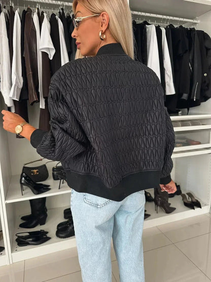 Women's quilted bomber jacket by Homixa featuring a zip-front closure and structured silhouette, shown on a model.