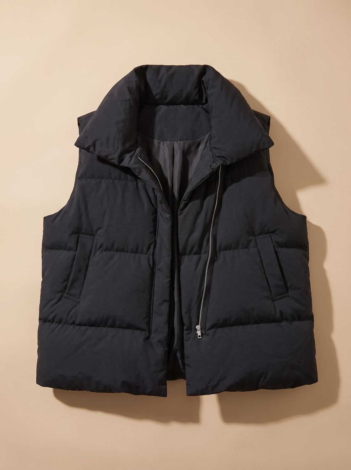 Women's Homixa quilted boxy-fit puffer vest with shawl collar and two-way zipper, showcasing its stylish design and cozy fit.