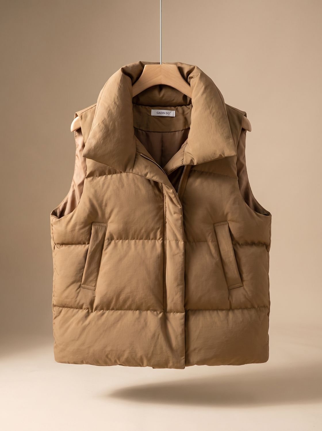Women's quilted boxy-fit puffer vest with shawl collar and two-way zipper, by Homixa, shown on a model.
