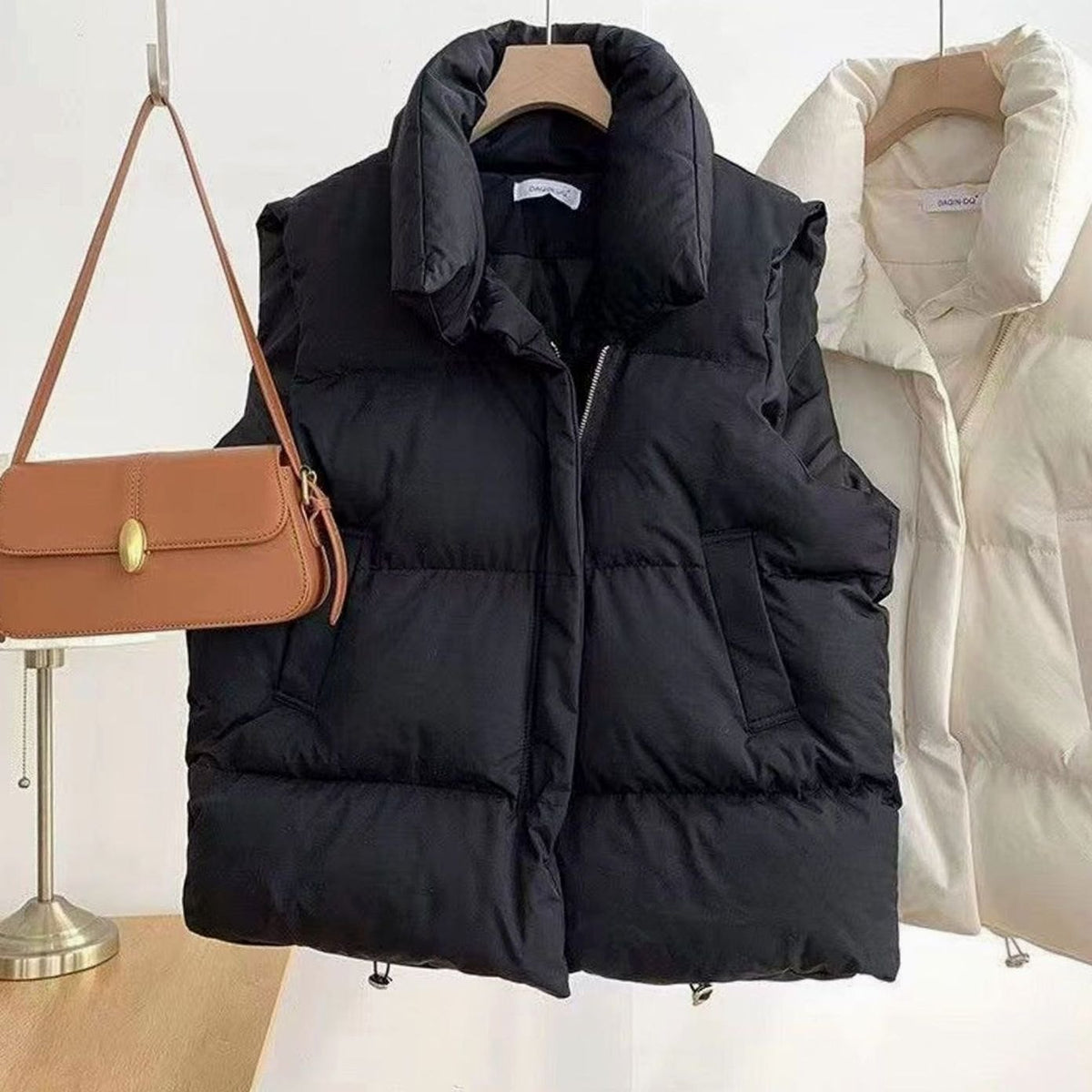 Women's quilted boxy-fit puffer vest with shawl collar and two-way zipper by Homixa, shown on a model.
