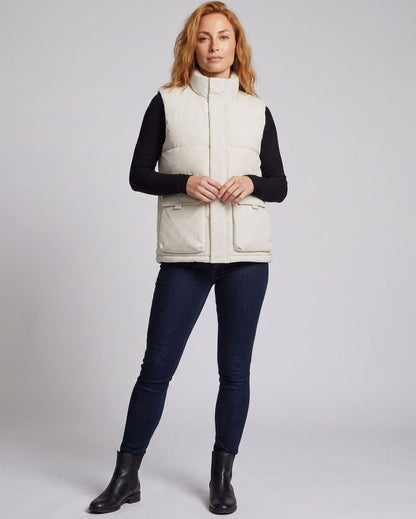 Women's quilted puffer vest with funnel neck, concealed zipper, and large flap pockets by Homixa.