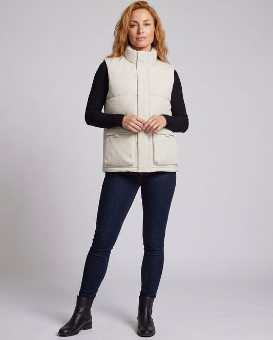 Women's quilted puffer vest with funnel neck, concealed zipper, and large flap pockets by Homixa.