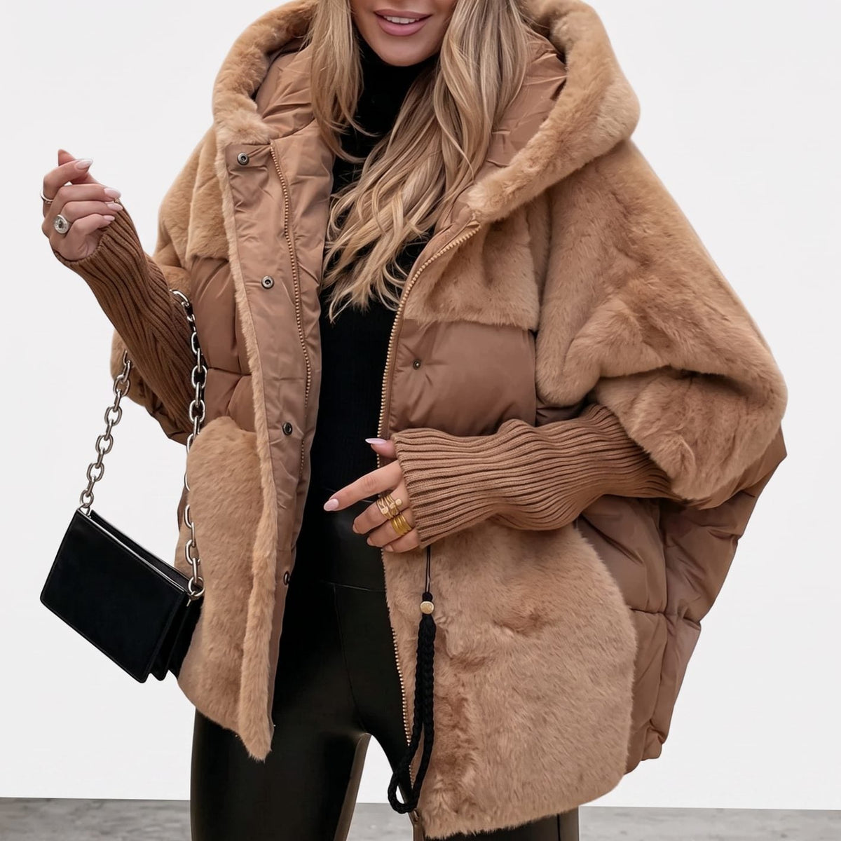 Women's quilted hooded midi coat by Homixa with faux-fur panels, extended ribbed cuffs, and a stylish, warm design.