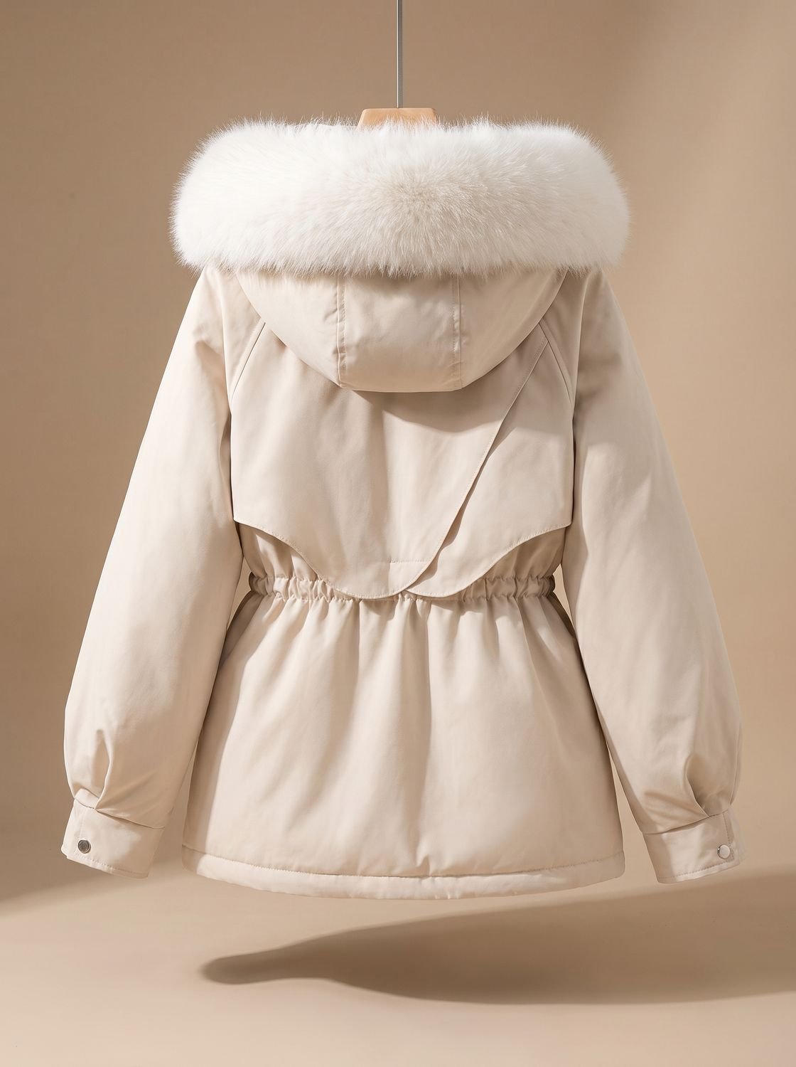 Women's quilted winter jacket by Homixa with hood, fur collar, and adjustable drawstring waist, ideal for cold weather.