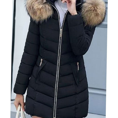 Women's Homixa quilted parka with vegan-fur hood trim, chevron pattern, and gold zippers, showcasing a stylish outerwear design.