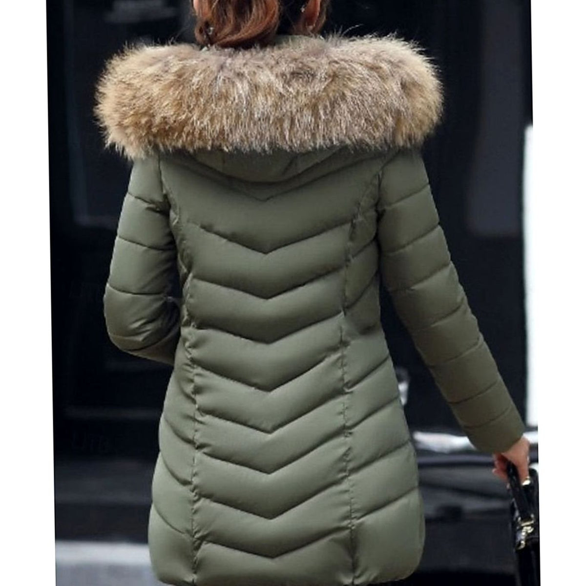 Women's quilted parka by Homixa with vegan-fur hood trim, chevron pattern, and gold zipper details.