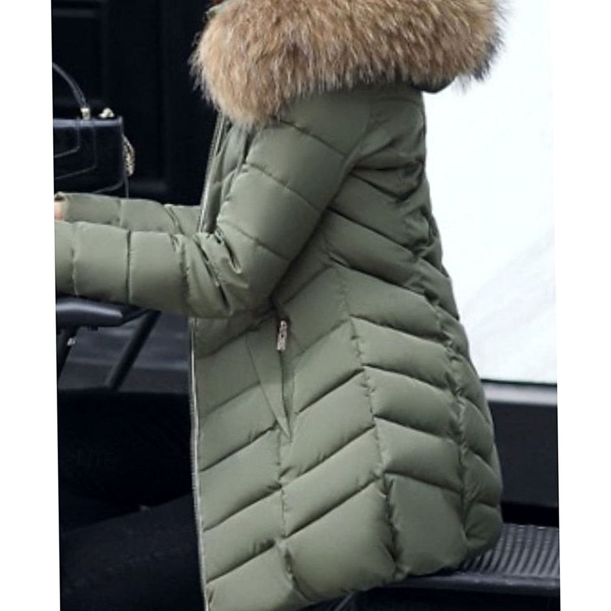 Women's quilted Homixa parka with vegan fur hood trim, chevron pattern, and gold zippers, shown on a model.