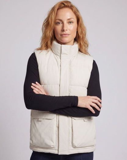 Women's quilted puffer vest by Homixa featuring a stand collar and flap pockets, sleeveless design with a stylish, padded look.