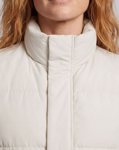 Women's quilted sleeveless puffer vest by Homixa featuring a stand collar and flap pockets, displayed on a neutral background.