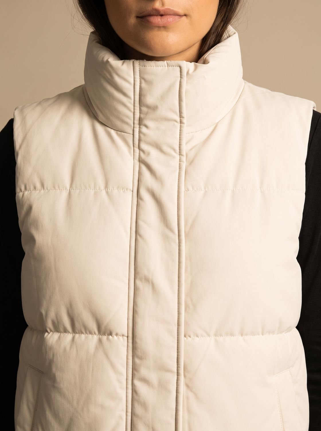 Women's quilted puffer vest by Homixa with stand collar, flap pockets, and hidden zipper for warm, stylish layering.