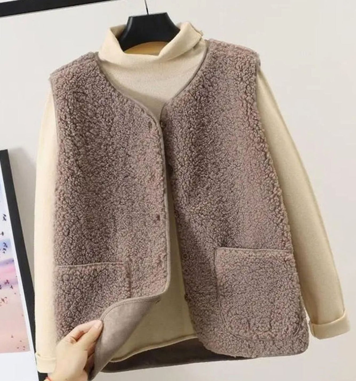Women's relaxed-fit Sherpa vest with button-front closure, sleeveless design, from Homixa, showcasing cozy fabric and casual style.