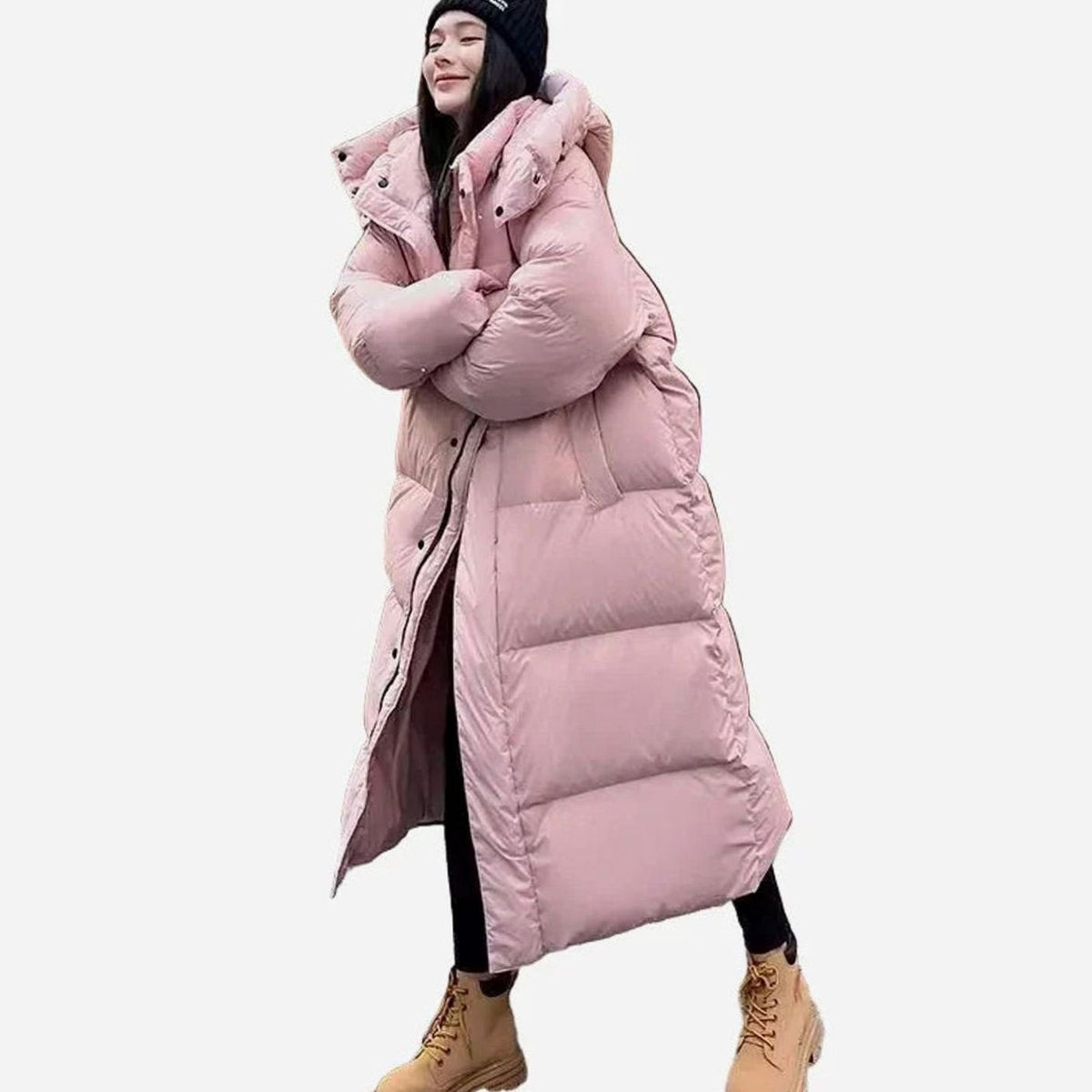 Women’s relaxed-fit long puffer coat by Homixa with side pockets and quilted hood, suitable for cold weather.