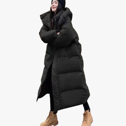 Women's relaxed-fit long puffer coat by Homixa with side pockets and quilted hood, designed for warmth and casual style.