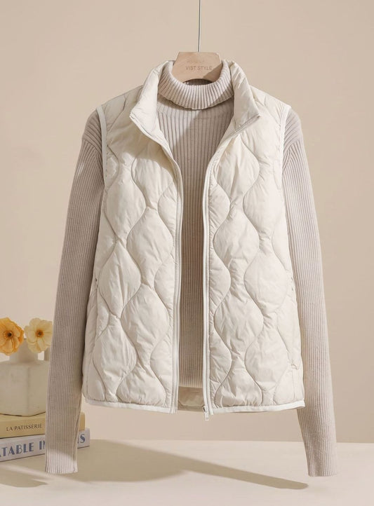 Women's relaxed-fit quilted puffer vest by Homixa with stand collar and warm filling, sleeveless design perfect for cold weather.