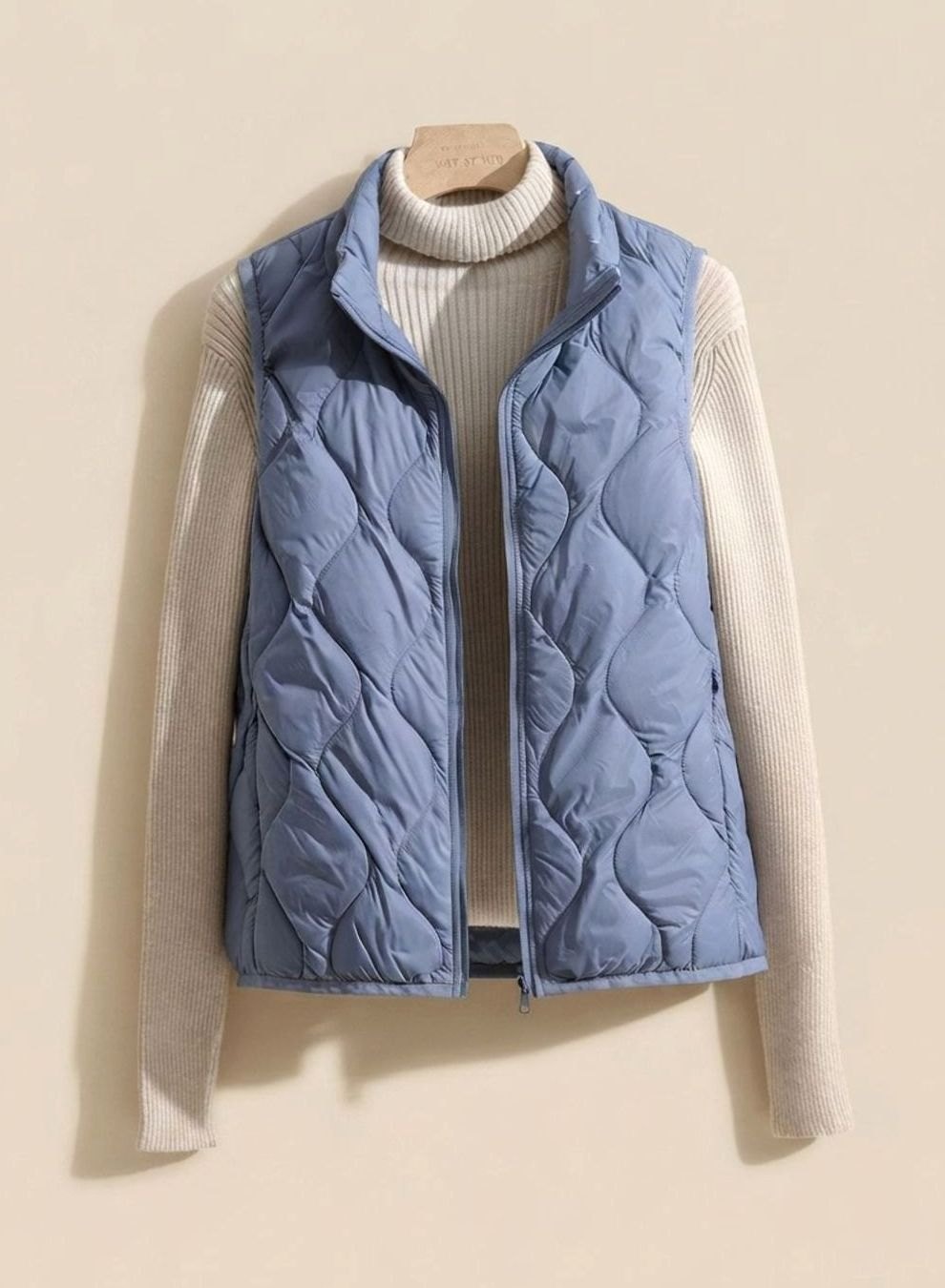 Women's relaxed-fit quilted puffer vest by Homixa with stand collar and warm filling, sleeveless design for casual winter wear.