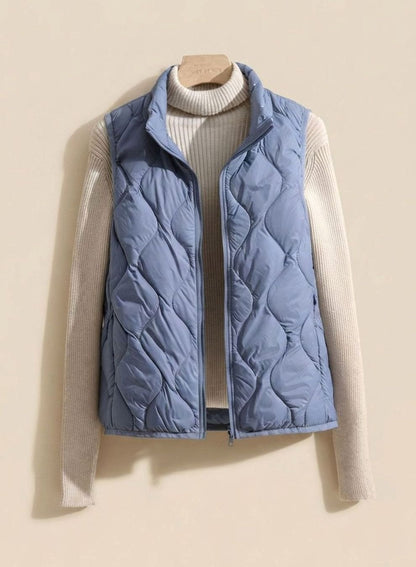 Women's relaxed-fit quilted puffer vest by Homixa with stand collar and warm filling, sleeveless design for casual winter wear.