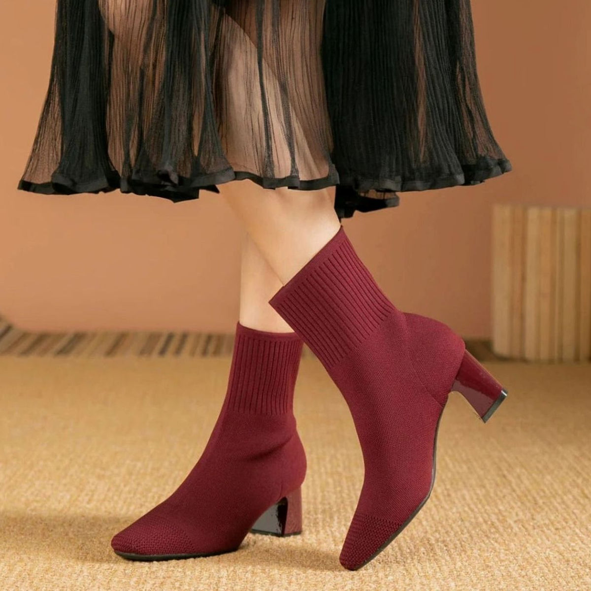 Homixa women's ribbed-knit sock booties with block heel and stretch pull-on shaft, showcasing stylish footwear design.