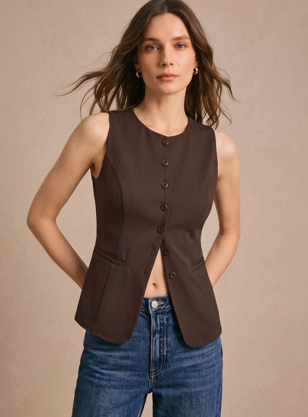 Women's sleeveless button-front vest by Homixa with fitted waist and curved front hem, displayed on a model.