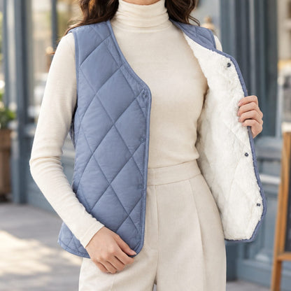 Women's sleeveless diamond-quilted vest by Homixa with Sherpa lining and snap front, displayed on a hanger.