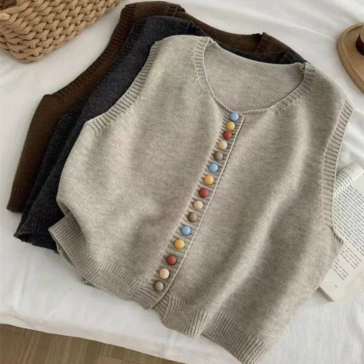 Women's sleeveless knit vest by Homixa featuring multicolored buttons, crew neck, and a stylish button-front design.