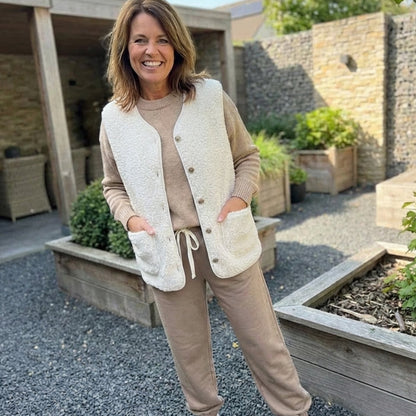 Women's sleeveless teddy fleece vest with V-neck, button front, and two pockets, by Homixa, shown in soft, cozy fabric.