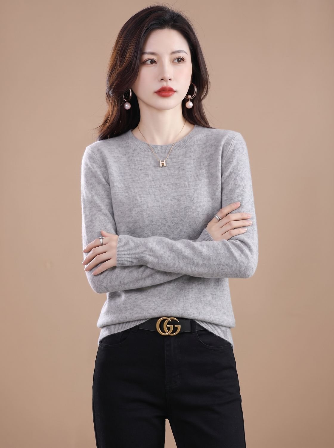 Women's soft cashmere crew-neck sweater with long sleeves and breathable knit fabric from Homixa, showcased on a model.
