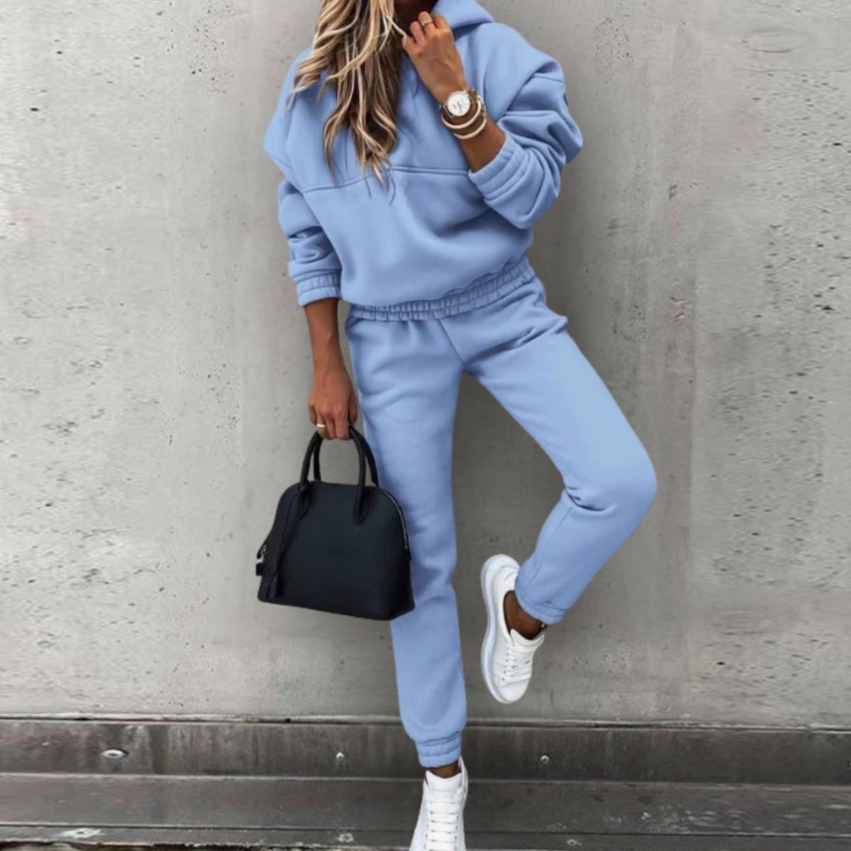 Women's Homixa stretch tracksuit set with relaxed hoodie and fitted jogger pants, shown in a comfortable, casual outfit.