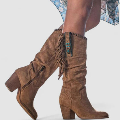 Women's suede fringe knee-high Western boots by Homixa featuring turquoise concho details and classic Western style.