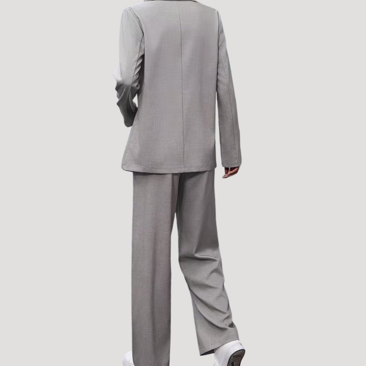 Women's tailored pant suit by Homixa featuring a double-breasted blazer and pleated wide-leg pants, suited for professional or formal wear.