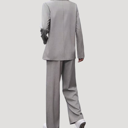 Women's tailored pant suit by Homixa featuring a double-breasted blazer and pleated wide-leg pants, suited for professional or formal wear.